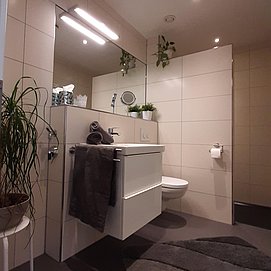 Badezimmer mit Lichtband und Handtuchheizkörper